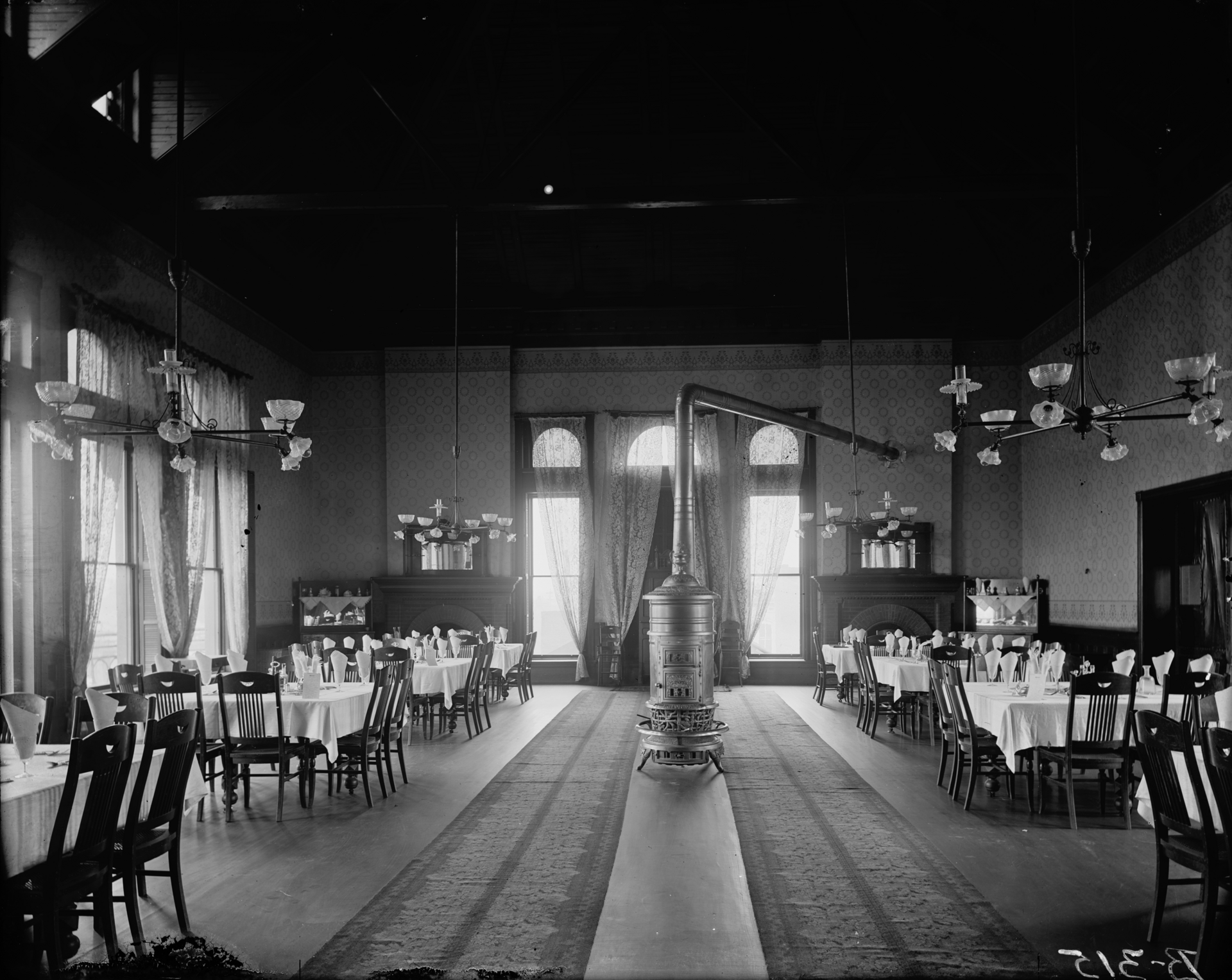 1890s Natchez Hotel dining room with combination gas-and-electric chandeliers